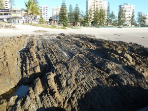 Figure 2. Example of the Neranleigh Fernvale Beds exposed on Rainbow Beach, near Snapper Rock at Coolangatta, Australia. These thick and thin beds have been tilted vertically, faulted such that they do not line up, and shaved off at the top.